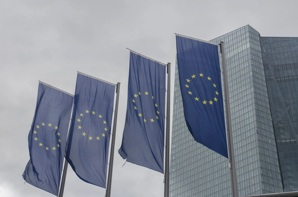 Abstract navy and gold toned photo of European Union flags outside an office building, representing the EU AI Act