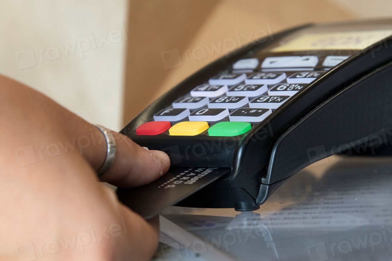 Abstract navy and gold toned photo of a hand using a card payment terminal, representing Stripe acquiring OpenRouter