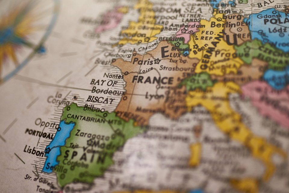 Abstract navy and gold toned close-up of a vintage atlas map, representing the ChatGPT Atlas browser shutdown