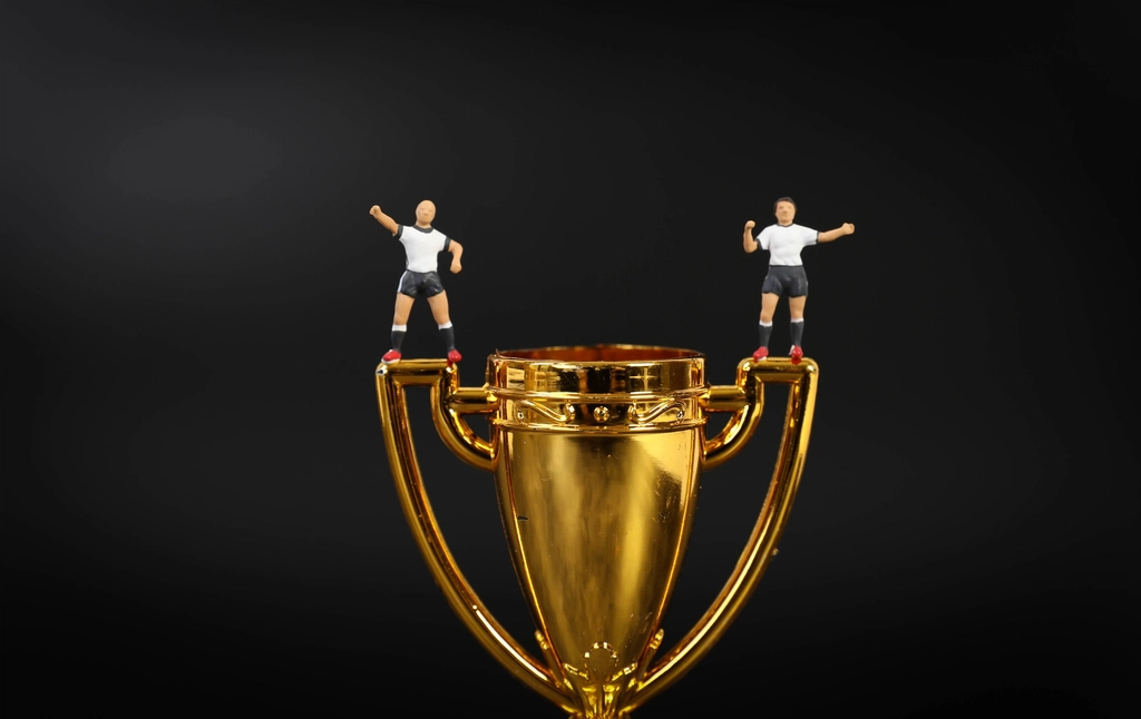 Abstract navy and gold toned photo of a golden trophy, representing another record month for new AI models