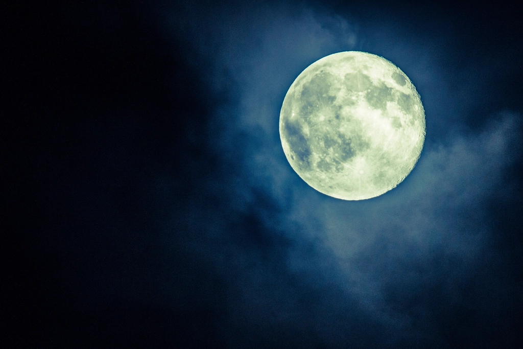 Abstract navy and gold toned photo of a full moon in a night sky, representing GPT-5.6 Luna