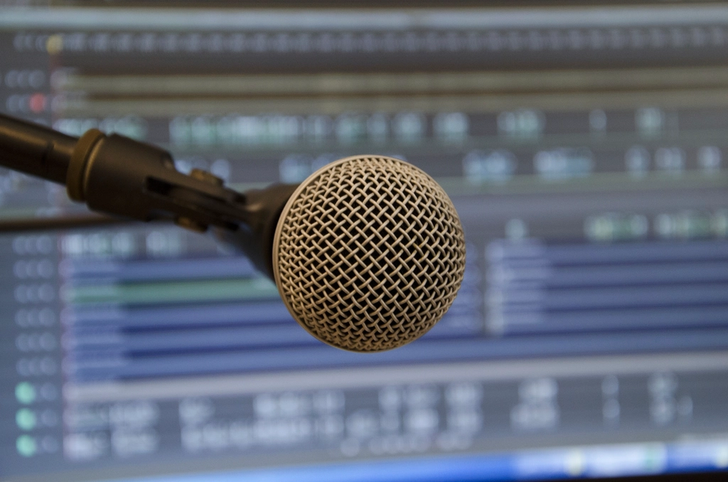 Abstract navy and gold toned close-up of a studio microphone, representing Grok Voice Think Fast 2.0