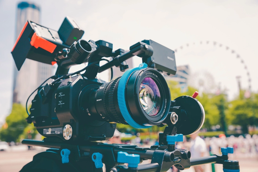Abstract navy and gold toned photo of a professional cinema camera rig, representing advancing media generation models