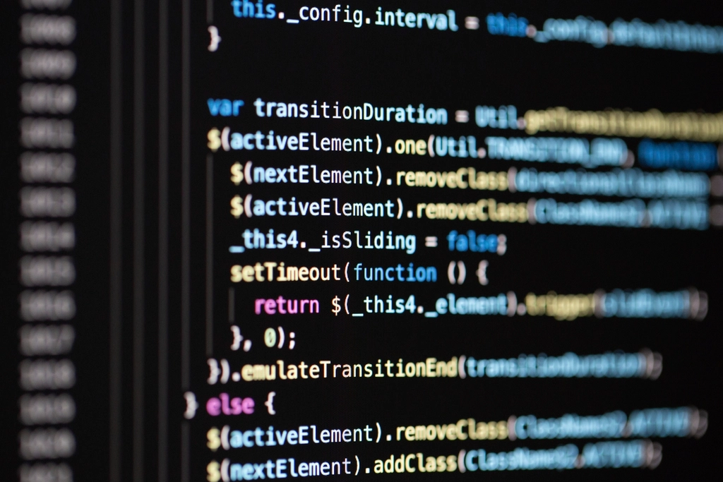 Abstract navy and gold toned close-up of source code on a screen, representing Cursor and its AI coding tools