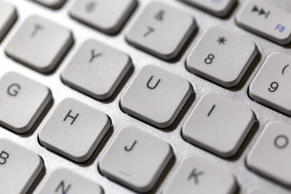 Close-up photo of laptop keyboard keys, representing the faster and cheaper Claude Sonnet 5.5 release