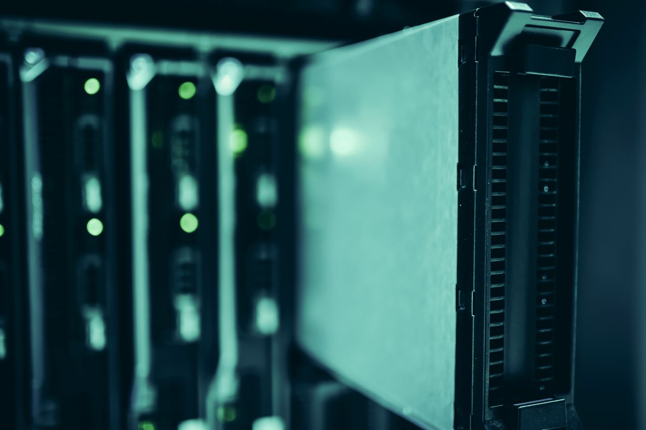Navy and gold toned photo of illuminated server hardware, representing websites blocking AI bots