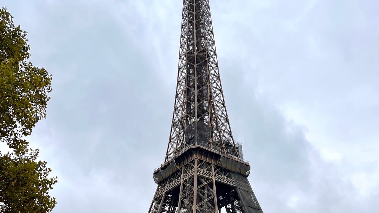 Navy and gold toned photo of the Eiffel Tower, representing French AI company Mistral