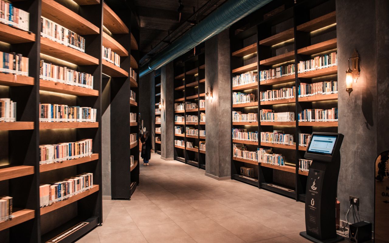 Navy and gold toned photo of library bookshelves, representing Wikimedia projects